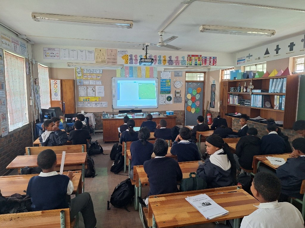 Students at a CodeLabs centre in Stellenbosch, South Africa, watching a lesson on the projector